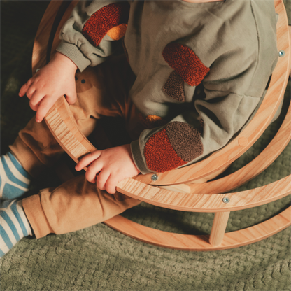 Dítě si hraje s dřevěným kruhem Ewart Woods