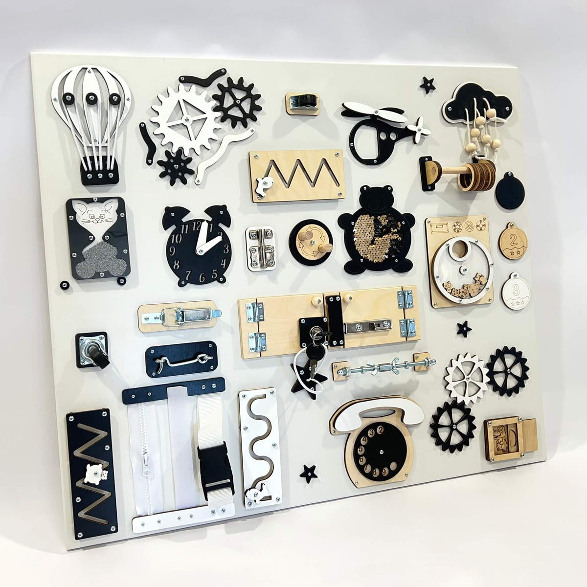 Velký activity board na zeď BusyBunnyToys 60 × 70 cm, černobílé provedení, pohled z boku